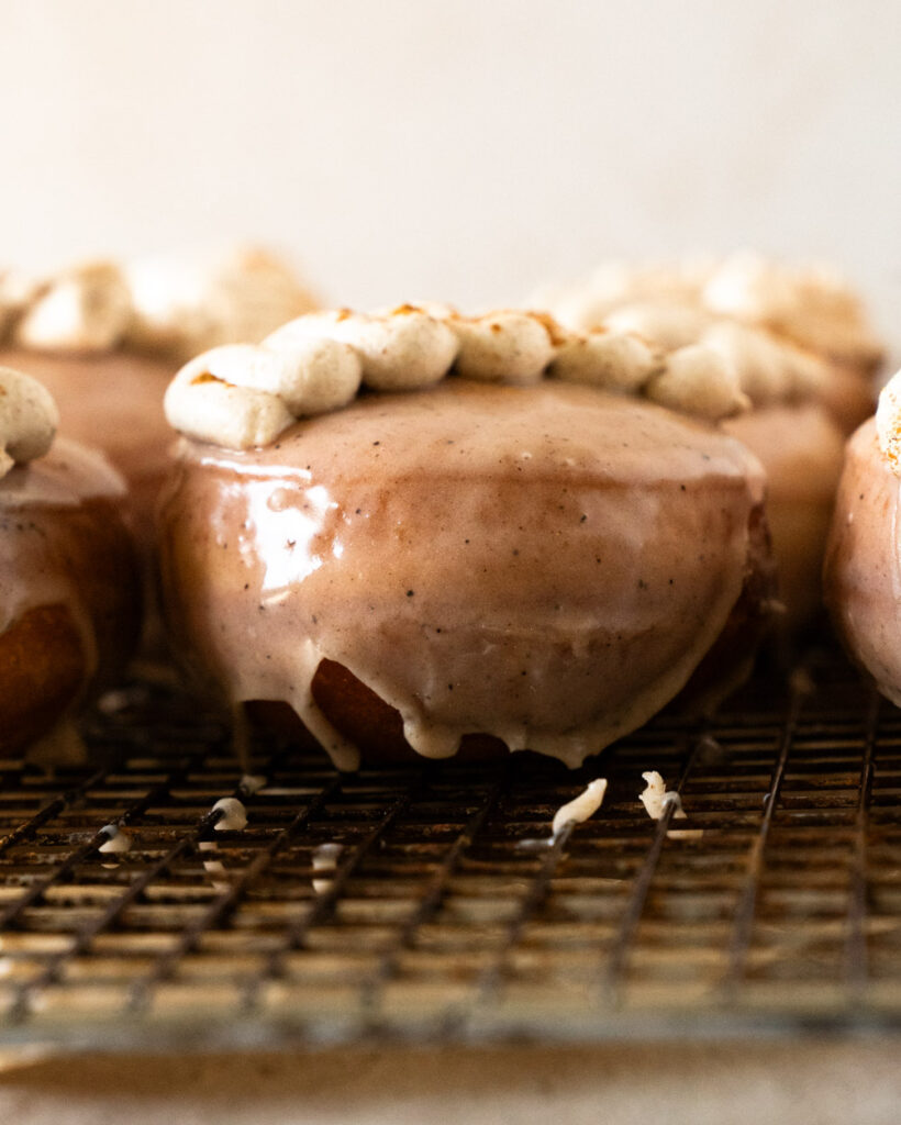 Close-up of a chai custard donut cut in half showing creamy spiced filling