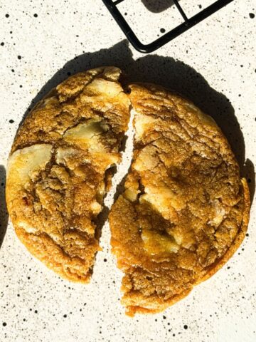 Pumpkin Cheesecake Chunk Cookies are chewy spiced pumpkin cookies loaded with white chocolate cream cheese bark and rolled in cinnamon sugar.