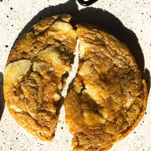 Pumpkin Cheesecake Chunk Cookies are chewy spiced pumpkin cookies loaded with white chocolate cream cheese bark and rolled in cinnamon sugar.